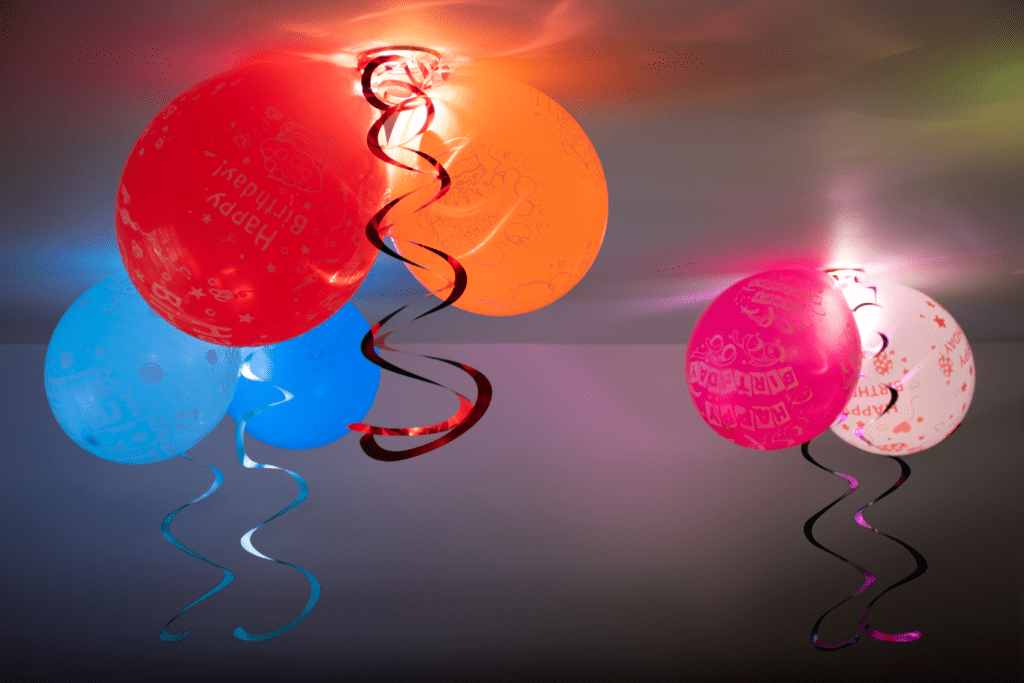 A bunch of balloons that are hanging from the ceiling